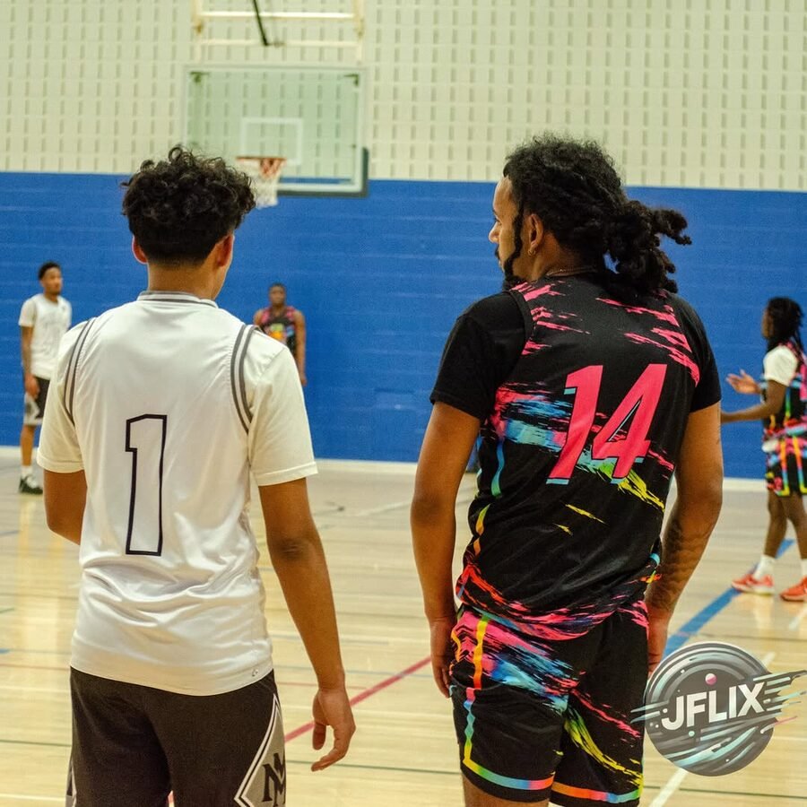 Two players side by side on the court between plays