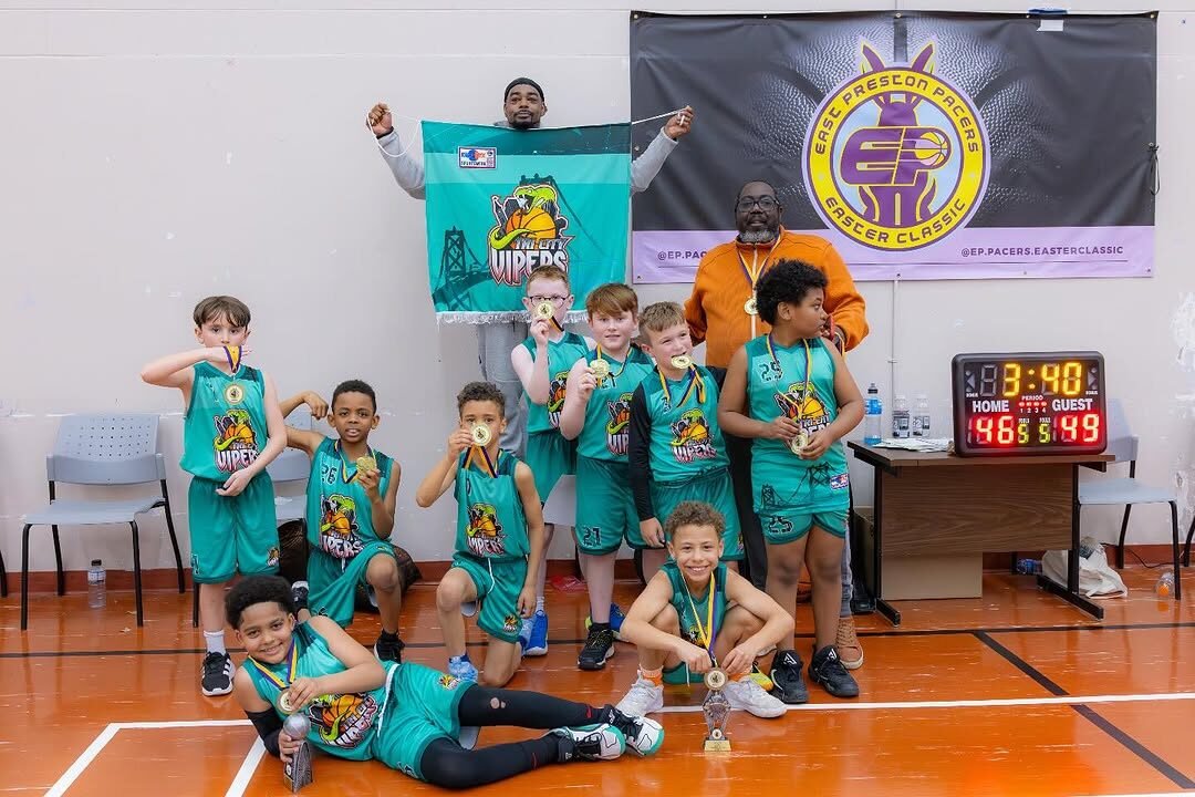 U10 Vipers team celebrating with medals and the club banner
